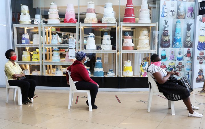 Customers sit on chairs outside a cake store as South Africa starts to relax some aspects of a stringent nationwide lockdown due to the coronavirus disease (COVID-19) outbreak in Johannesburg, South Africa